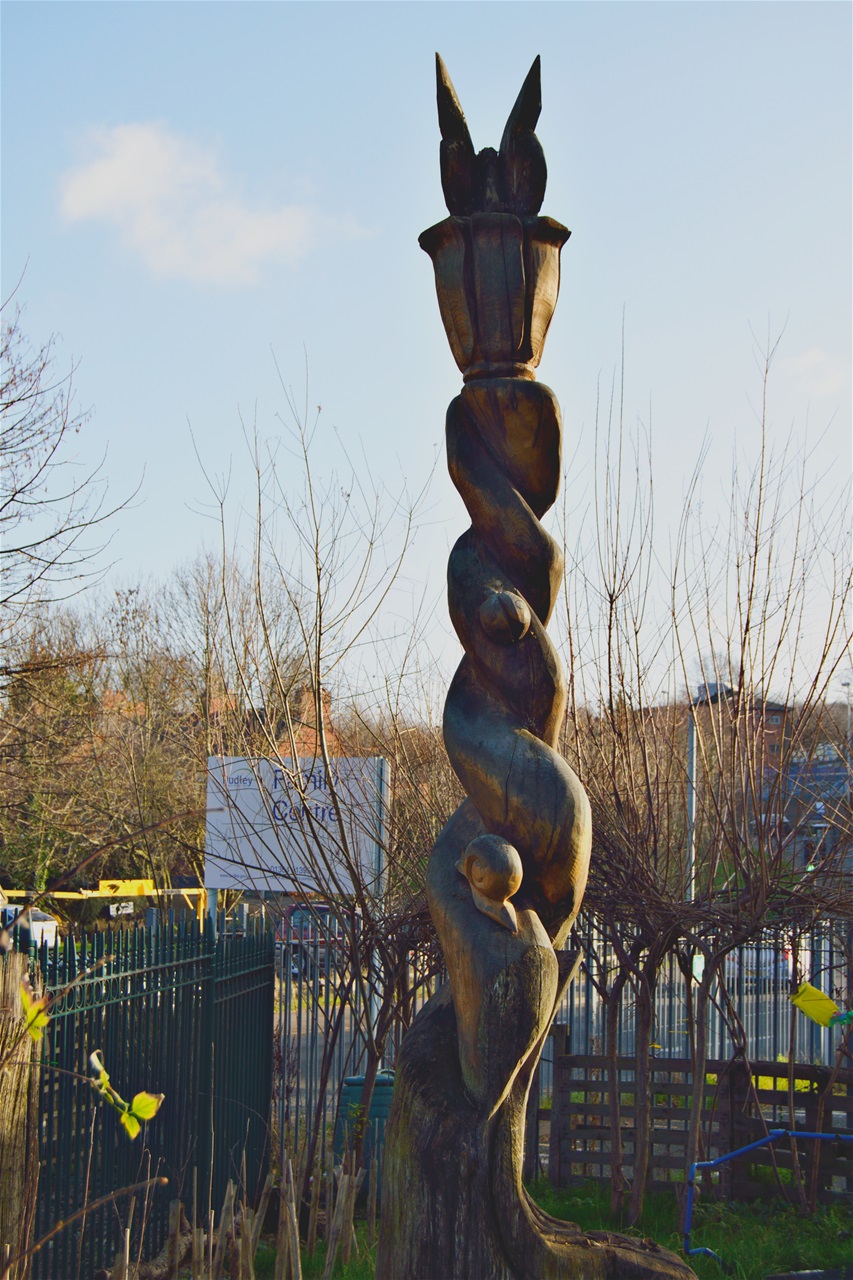 Wooden totem pole in small park behind Church.Jan 2020 noticed it was missing
